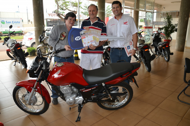 1° Prêmio - Uma Moto Honda FAN 125 KS - Associação de Campista Maria de Jesus - Dourados/MS - Cartela 3383